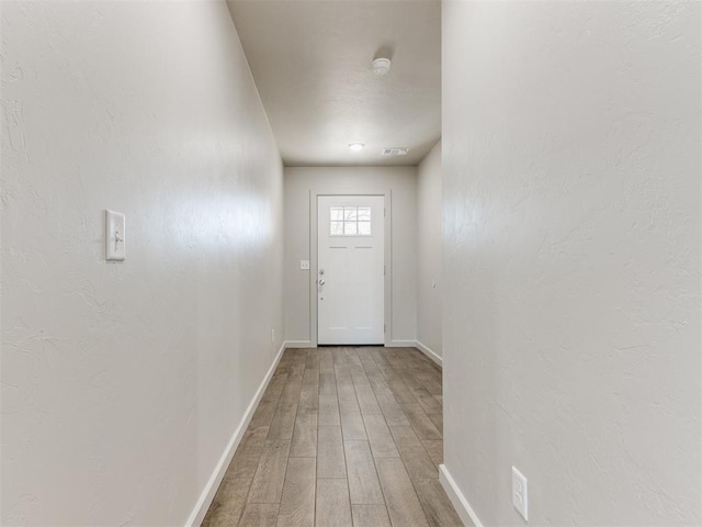 doorway to outside with hardwood / wood-style flooring