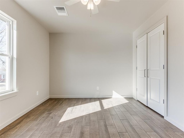 unfurnished room with ceiling fan and light hardwood / wood-style floors