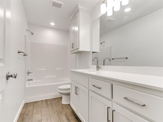 full bathroom with vanity, tub / shower combination, hardwood / wood-style floors, and toilet