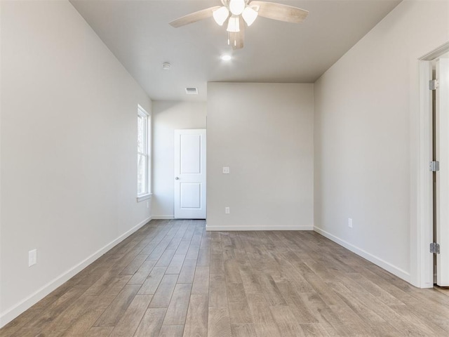 unfurnished room with ceiling fan and light wood-type flooring