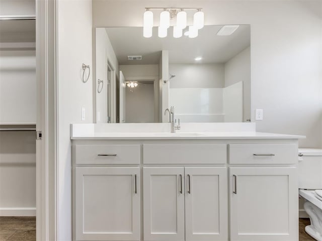 bathroom with a shower and vanity