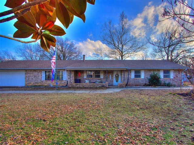 ranch-style home with a garage and a front lawn