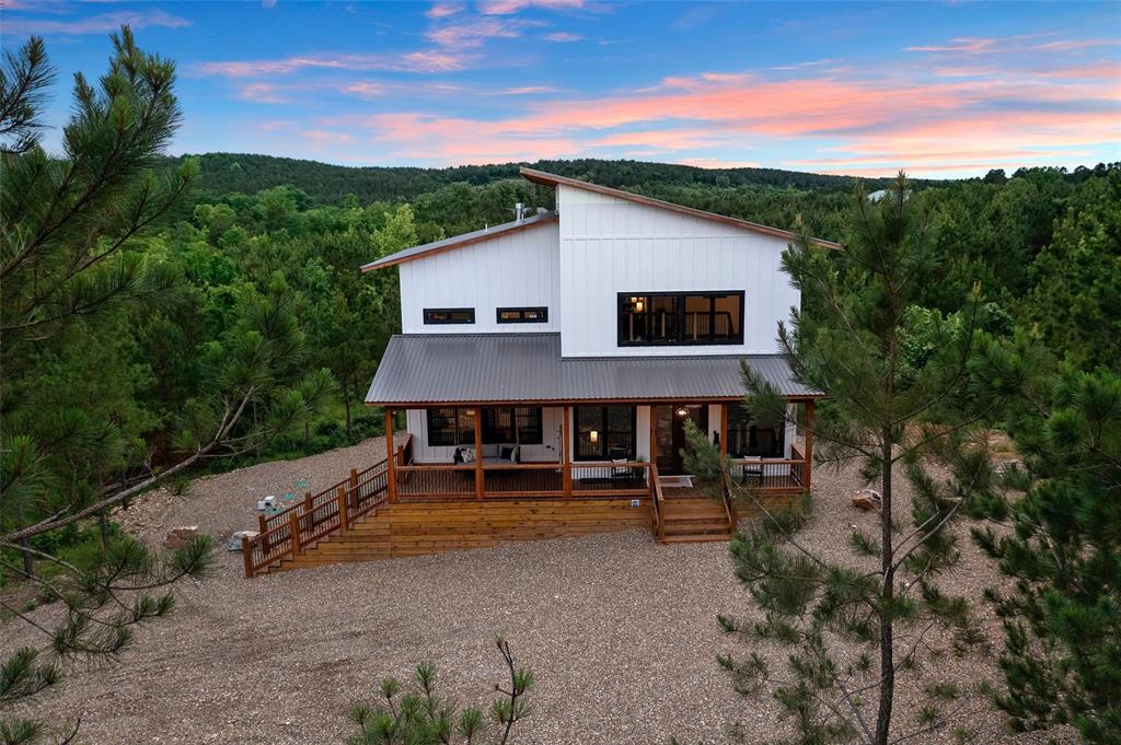 back house at dusk with covered porch