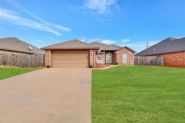 ranch-style house featuring a garage and a front yard