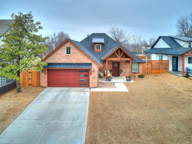 view of front of home featuring driveway, roof with shingles, fence, and brick siding