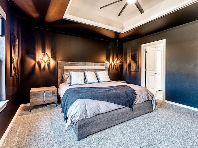 bedroom featuring a raised ceiling, carpet floors, and ceiling fan