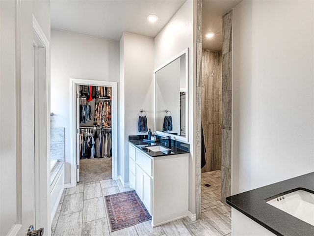 bathroom featuring vanity and a tile shower