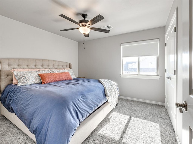 bedroom with ceiling fan and light carpet