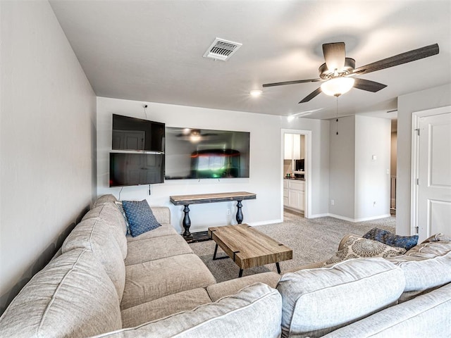 carpeted living room with ceiling fan