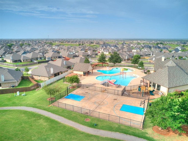 view of swimming pool with a playground and a yard