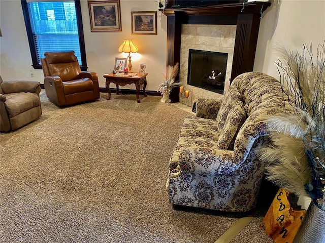 living room with carpet and a fireplace