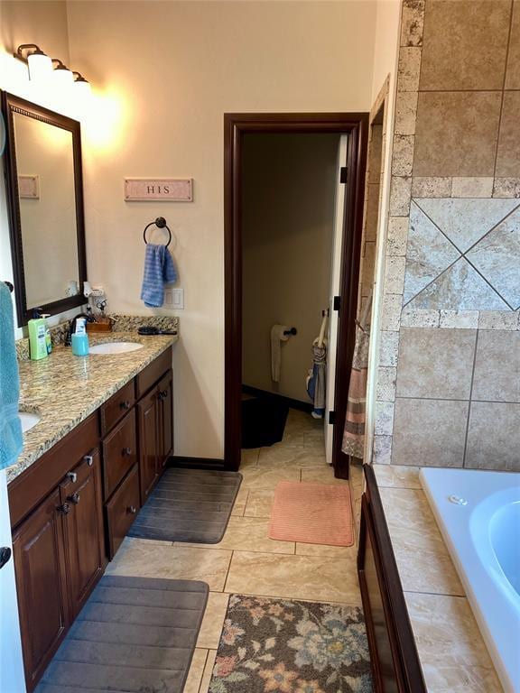 bathroom featuring a relaxing tiled tub and vanity