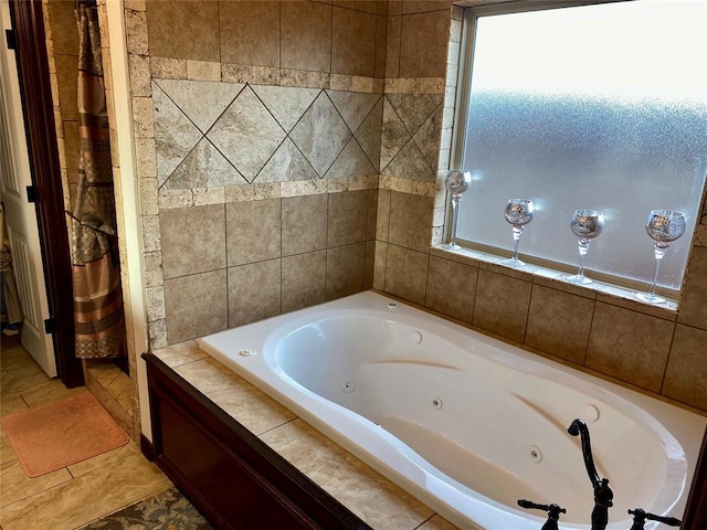 bathroom featuring a relaxing tiled tub and tile patterned floors