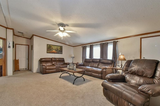 living room featuring ceiling fan, light colored carpet, ornamental molding, and a textured ceiling