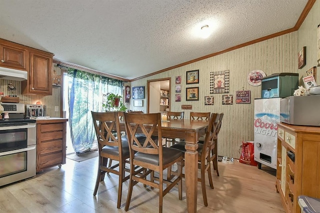 dining space featuring crown molding, lofted ceiling, light hardwood / wood-style floors, and a textured ceiling