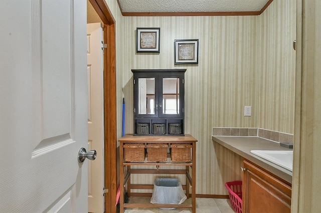 bathroom with vanity, tile patterned flooring, and a textured ceiling