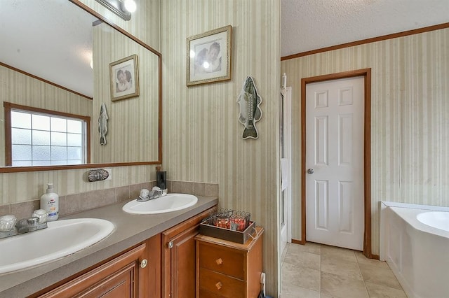 bathroom with tile patterned flooring, vanity, a textured ceiling, and a tub to relax in