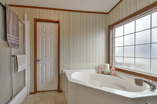 bathroom featuring ornamental molding, separate shower and tub, tile patterned flooring, and a wealth of natural light