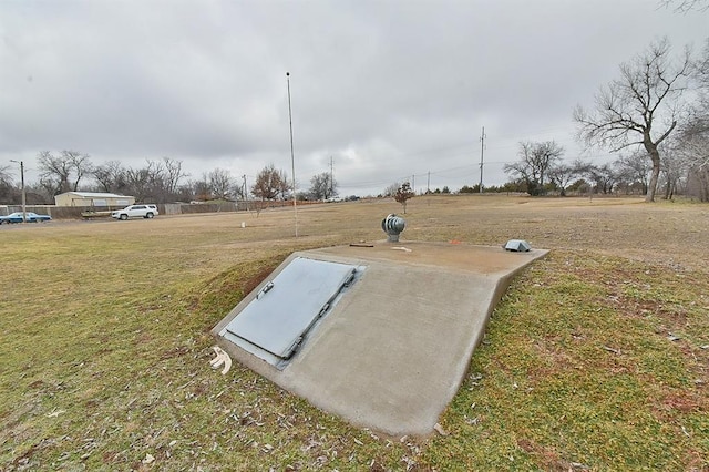 view of storm shelter featuring a lawn