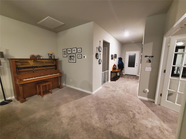 sitting room featuring baseboards and carpet flooring