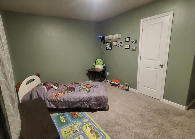 bedroom featuring baseboards and carpet flooring