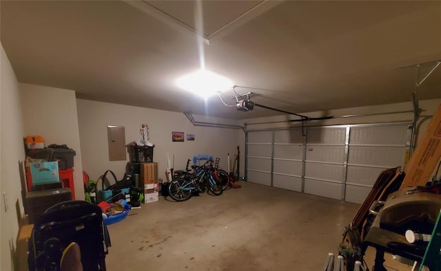 garage featuring a garage door opener and electric panel