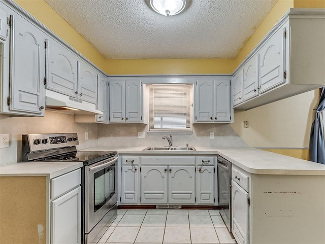 kitchen with sink, light tile patterned floors, appliances with stainless steel finishes, gray cabinetry, and tasteful backsplash