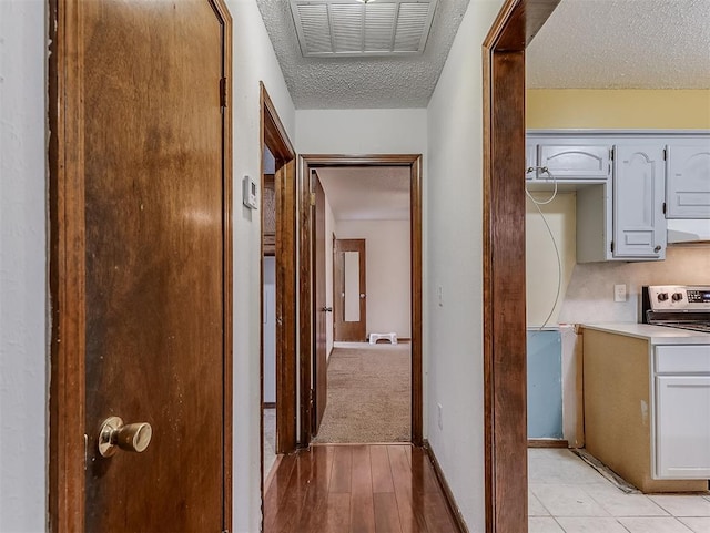 hallway with a textured ceiling