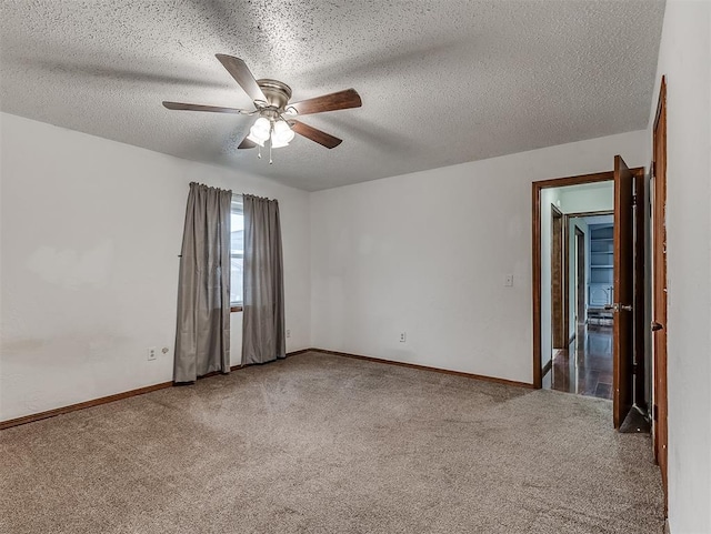 carpeted spare room featuring ceiling fan and a textured ceiling