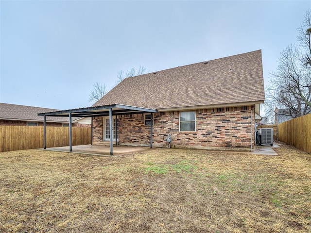 back of house with a lawn, cooling unit, and a patio area