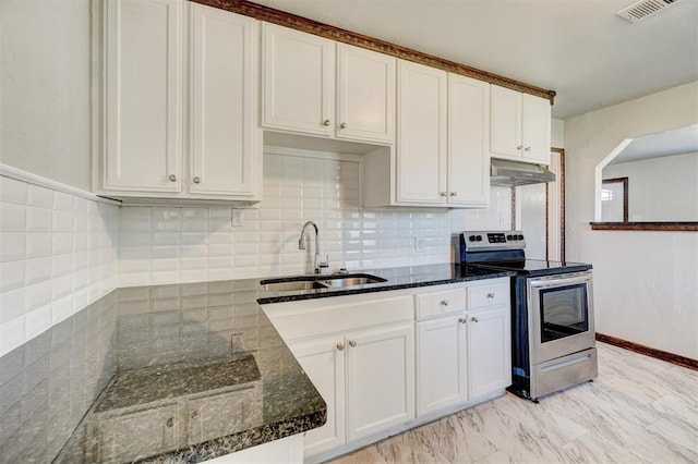 kitchen with stainless steel range with electric stovetop, sink, dark stone counters, and white cabinets