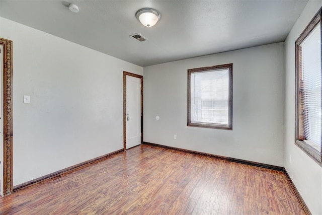 unfurnished room featuring hardwood / wood-style flooring