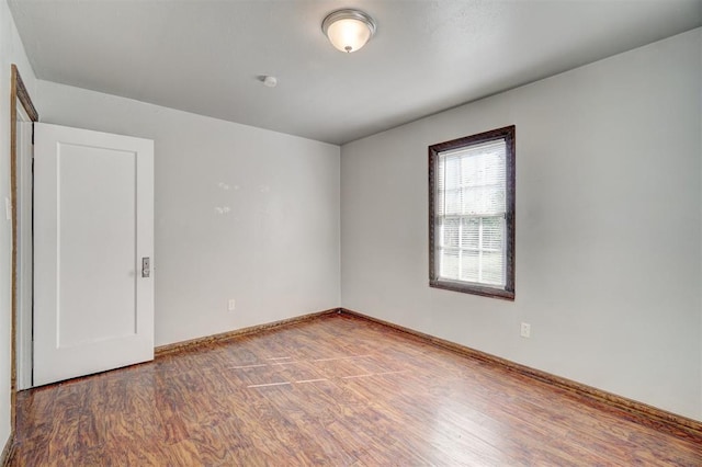 spare room with hardwood / wood-style flooring