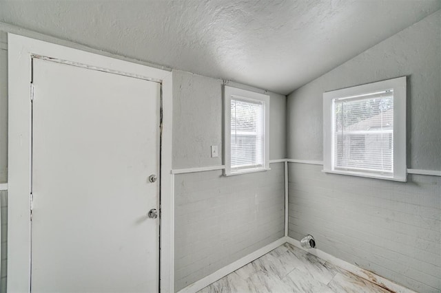 laundry area with a textured ceiling