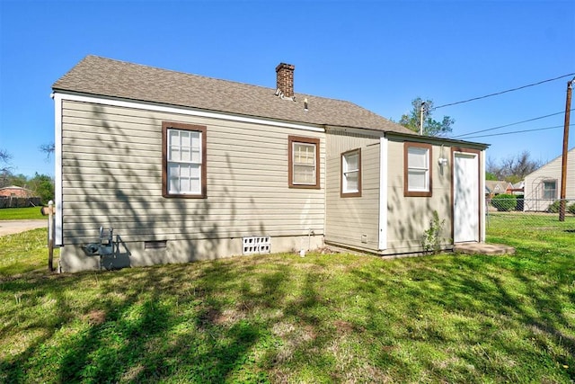 back of house with a lawn