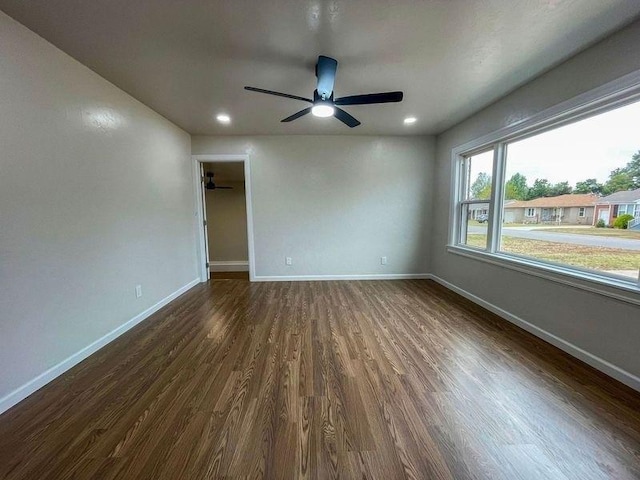 unfurnished room with ceiling fan and dark hardwood / wood-style flooring