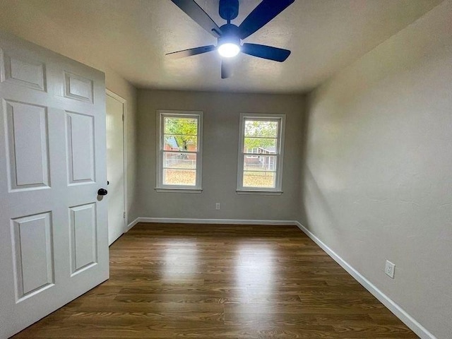 unfurnished bedroom featuring dark hardwood / wood-style flooring and ceiling fan