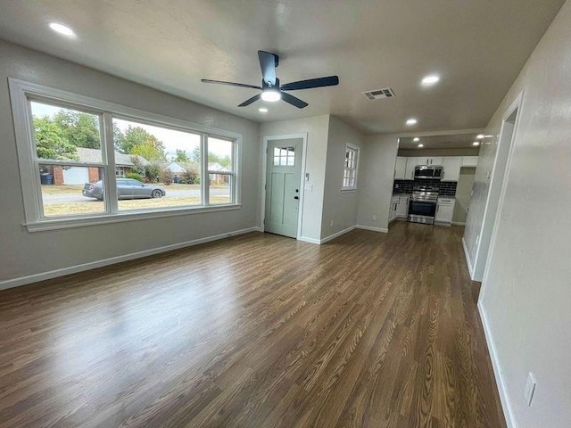 unfurnished living room featuring dark hardwood / wood-style flooring and ceiling fan