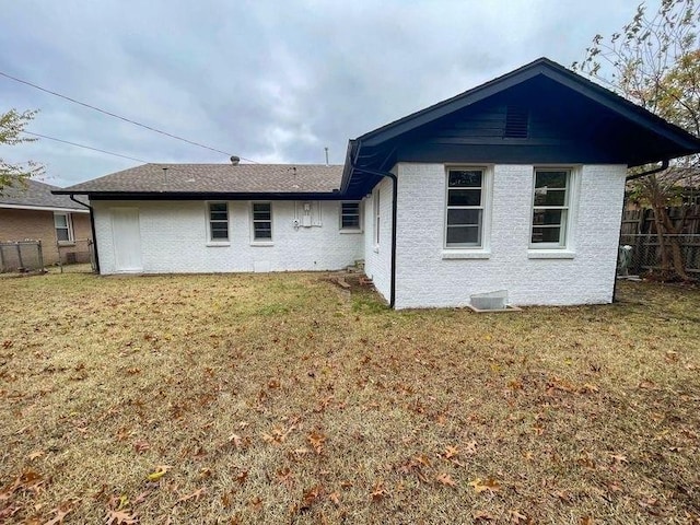 rear view of house with a lawn