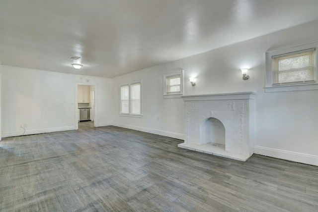 unfurnished living room with hardwood / wood-style floors and a fireplace