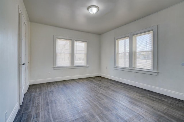 spare room with dark hardwood / wood-style flooring