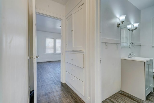 corridor featuring dark hardwood / wood-style flooring and sink