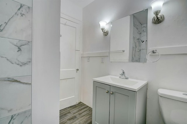 bathroom with vanity, hardwood / wood-style floors, and toilet