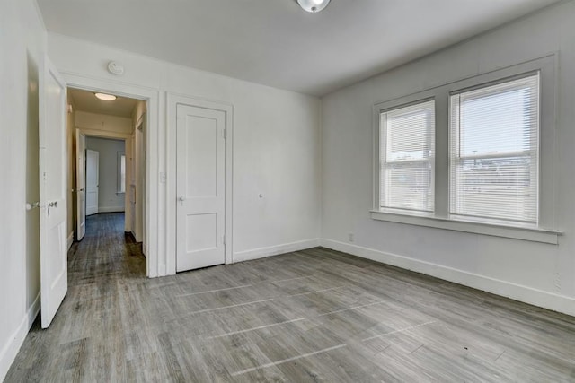 unfurnished room with light wood-type flooring