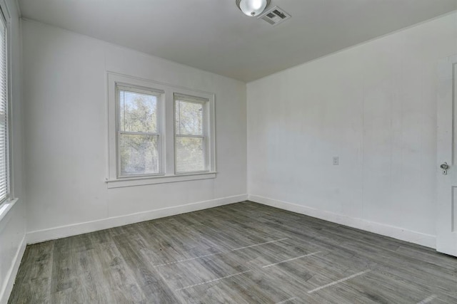 unfurnished room with hardwood / wood-style floors