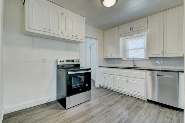 kitchen with sink, white cabinets, and appliances with stainless steel finishes