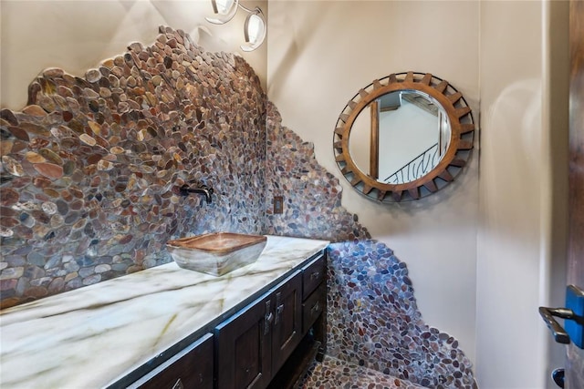 bathroom featuring tasteful backsplash and vanity