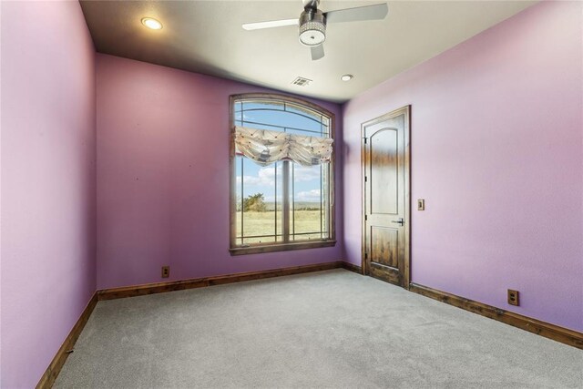 carpeted spare room with ceiling fan