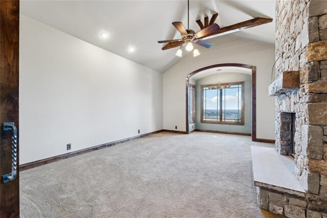 unfurnished living room with a stone fireplace, carpet floors, lofted ceiling, and ceiling fan