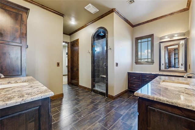 bathroom with a shower with door, ornamental molding, and vanity